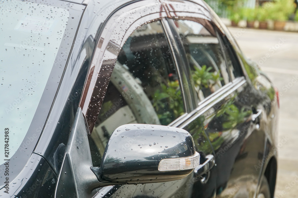 Fototapeta premium close up wing mirror with LED light bar of black car