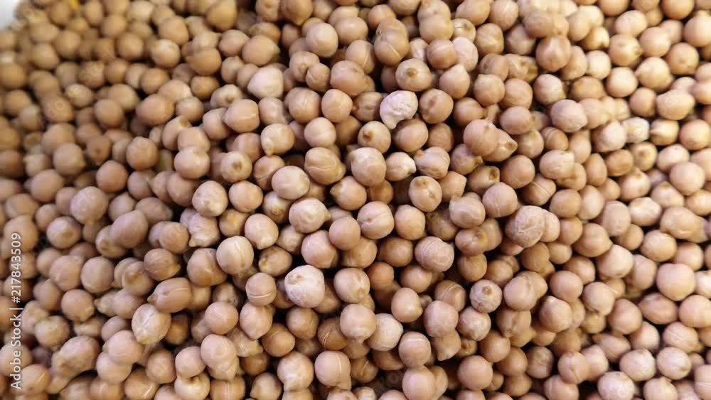 A man moves Chickpea beans in the sac A man moves Chickpea beans in the sac