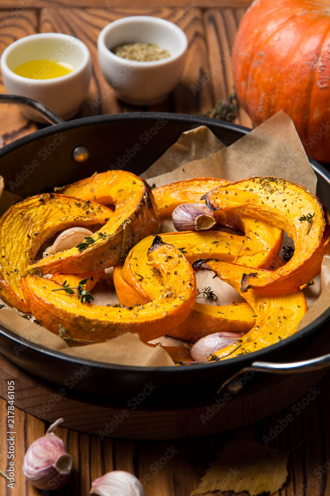 Baked pumpkin with thyme, olive oil and garlic, delicious autumn dish.