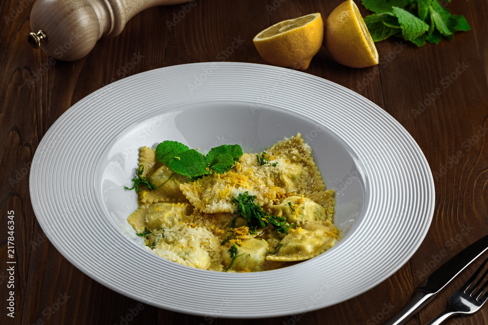 Ravioli filled with ricotta, mint and grated lemon rind on a rustic