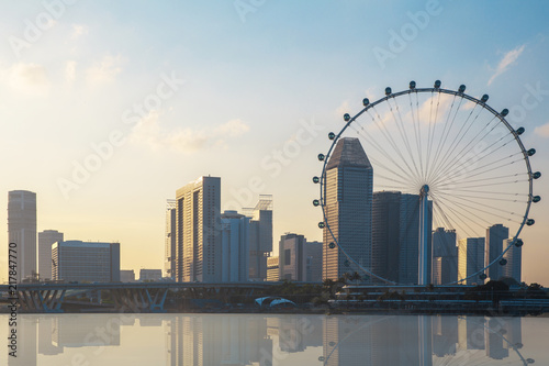 Singapore business district city and building with the Singapore Flyer gian Ferris wheel and the bridge