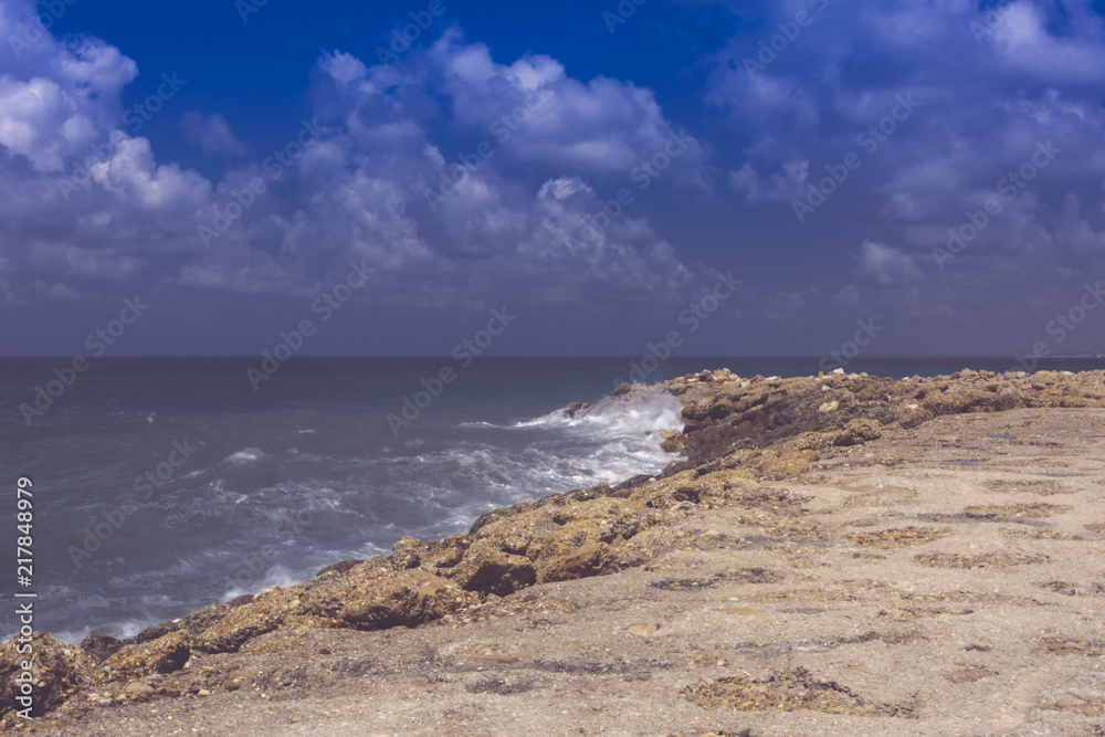 summer southern view of the sea shore. the wave runs on the rocks. vintage dark gray tinted