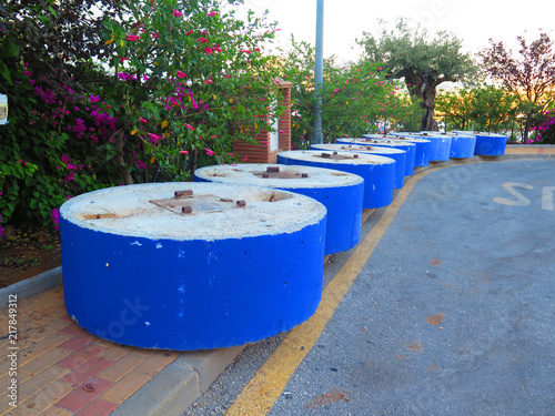 Blue painted concrete bases waiting in row photo