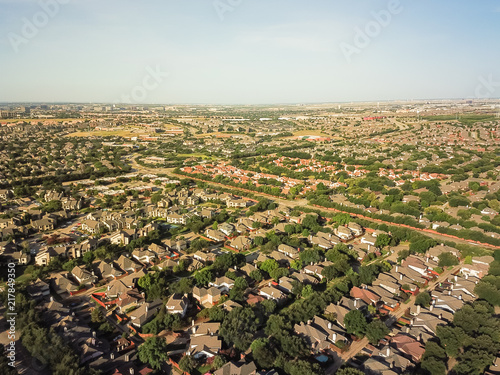 Aerial view urban sprawl near downtown Dallas, Texas, USA. Suburban tightly packed homes neighborhood with driveways, apartment building complex flyover. Vast suburbia subdivision in Irving, Texas, US