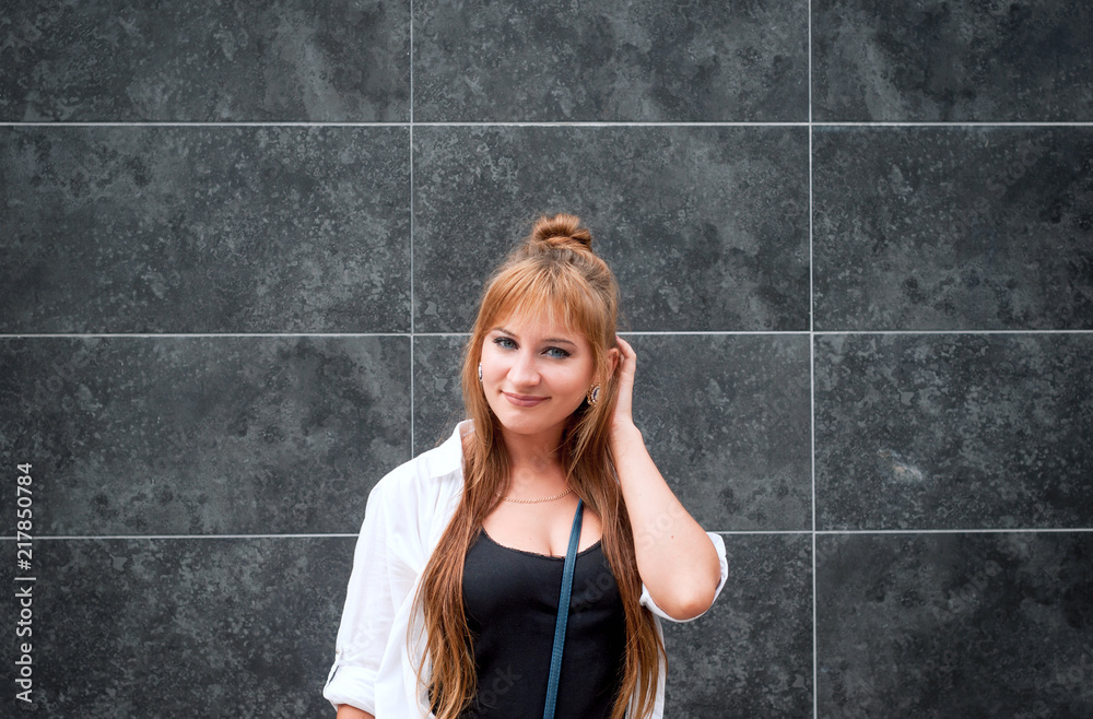 Hipster girl on a dark stone background making a gesture of doubt, distrust . Human face expressions, emotions, feelings concept. Hipster girl on a dark stone background making a gesture of doubt, distrust . Human face expressions, emotions, feelings concept.