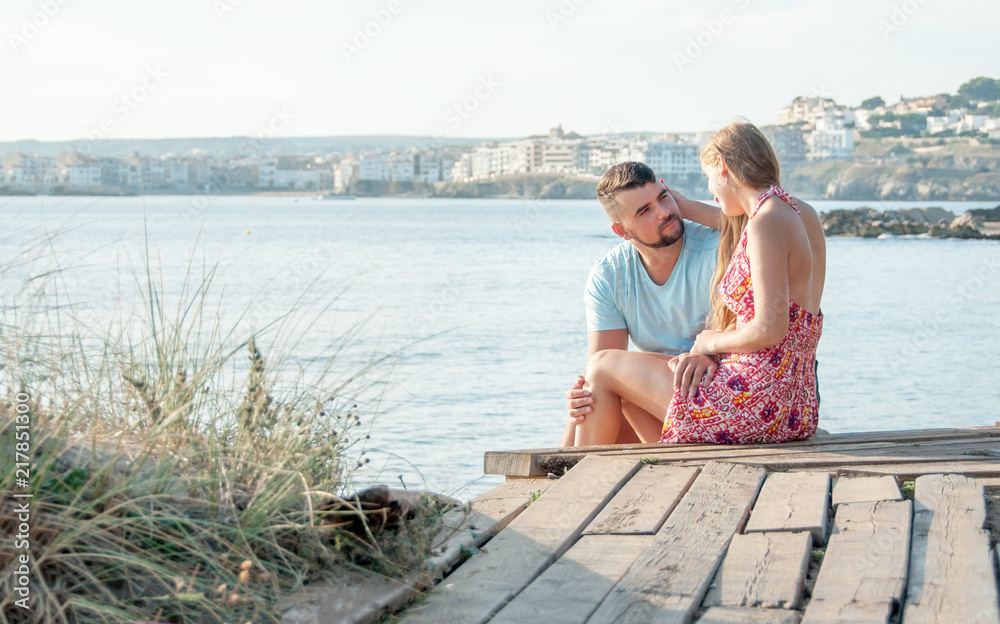 Fototapeta premium Romantic young couple on the beach. Young couple enjoy each other on vacation.