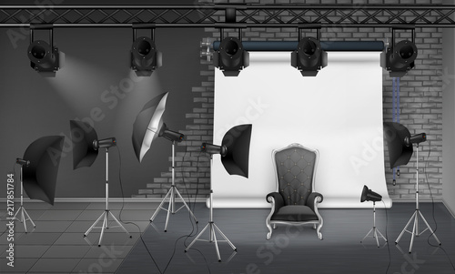 Vector photo studio interior with empty armchair, gray brick wall, white projector screen, spotlights and softboxes on tripods. Mockup with modern lighting equipment for professional photography