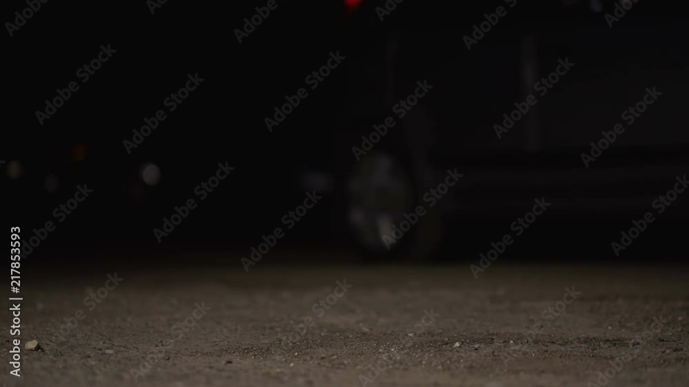Man running after stolen auto in parking lot at night, car theft and insurance