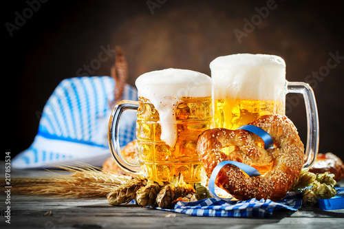 Beer mugs and pretzels on a wooden table. Oktoberfest. Beer festival. photo