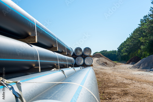 storage place of big plastic pipes for  heating, plimbing, sewage on a building site