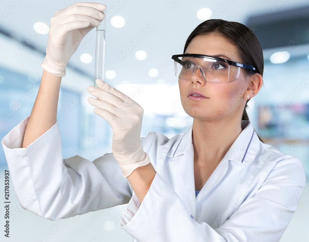 Young female scientist standing in her lab. Young female scientist standing in her lab.