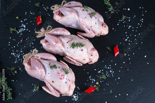 Raw uncooked seasoned partridges .Ingredients for cooking healthy meat dinner.