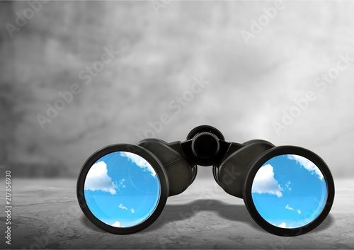 Close up of black binocular with sky in glasses isolated on