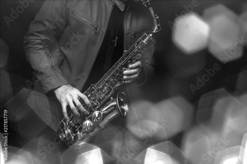 Jazz saxophone player in performance on the stage. color filter and hexagon bokeh added.