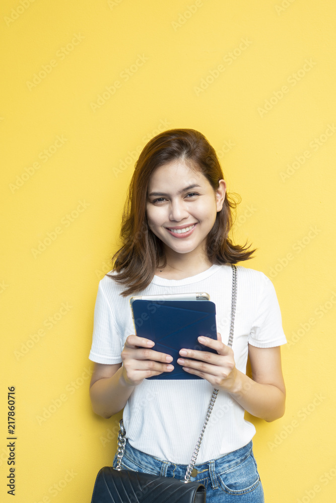 portrait of beautiful university student are smiling on yellow wall background portrait of beautiful university student are smiling on yellow wall background