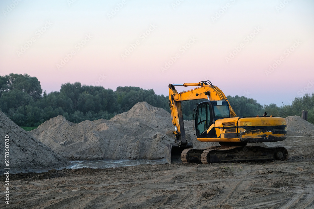 excavator is standing on the sand