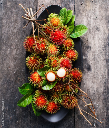 fresh rambutan with green leaf. photo