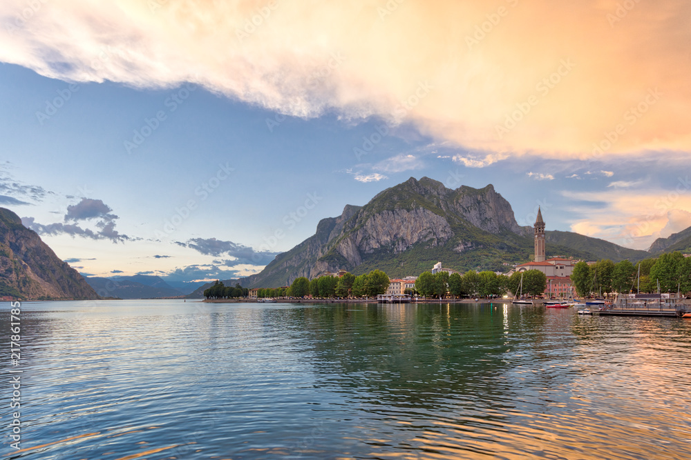 Shining panorama of Lecco Lake at the sunset with huge colorful cloud