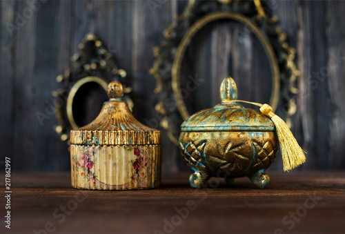 Vintage Caskets and bottles and bronze antique frames on a wooden background