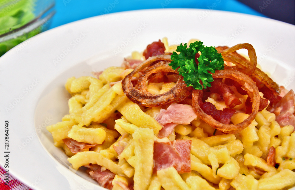 Spätzel or Spaetzel or soft egg noodle fried with ham ,cheese and Topped with fried onions and bacon. Spätzel or Spaetzel or soft egg noodle fried with ham ,cheese and Topped with fried onions and bacon.
