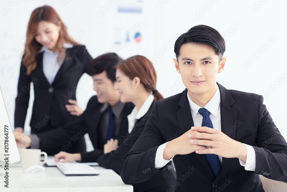 smiling business man with colleagues on background smiling business man with colleagues on background