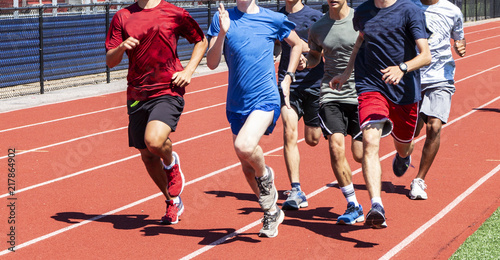 Group of runners training on a track together