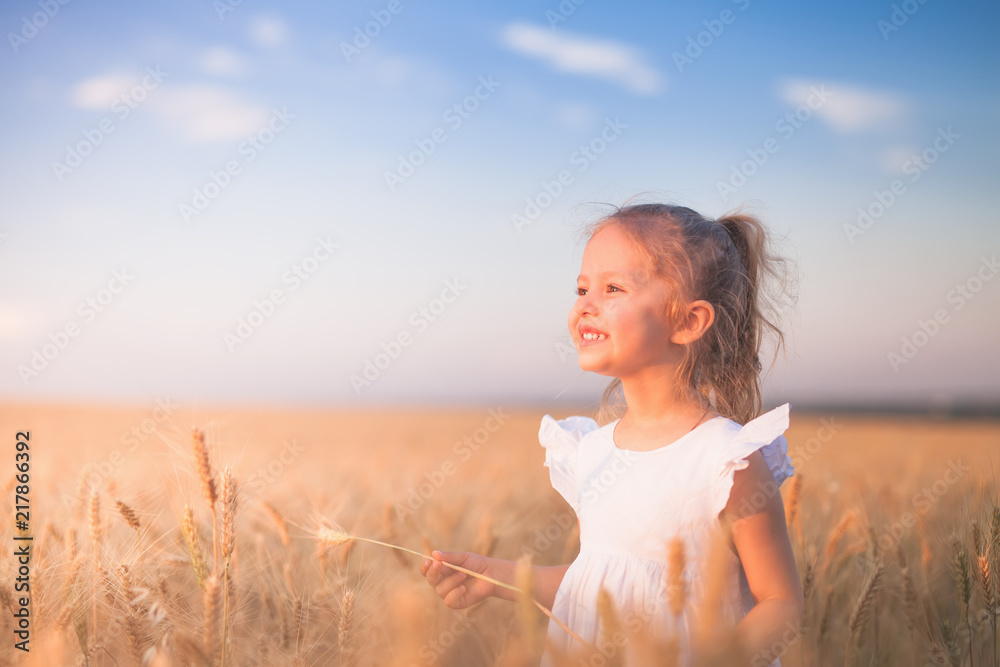 Happy Little Girl Outdoor At Wheat Field. End of Summer Happy Little Girl Outdoor At Wheat Field. End of Summer