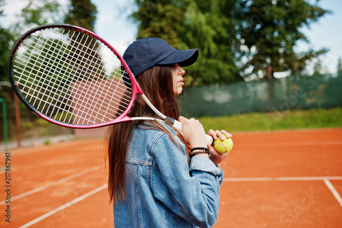 Young sporty girl player with tennis racket on tennis court. © AS Photo Family