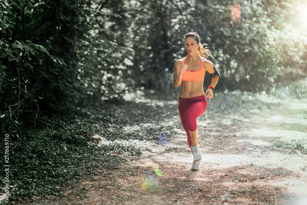 Young female athlete jogging in the park Young female athlete jogging in the park