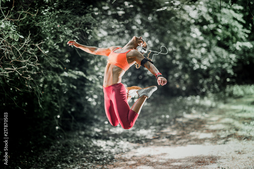 Female athlete jumping in the park