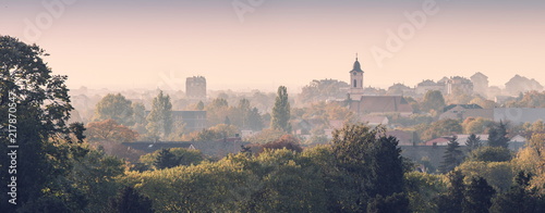 Zemun, old city with churches and houses with red roofs,on a foggy, misty morning photo
