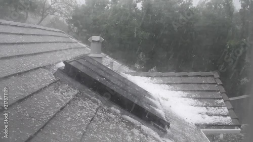 Hail storm on the roof of a house photo