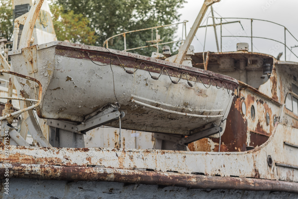 Rusty weathered old white fishing boat in the harbor on the Dnieper River, Ukraine
