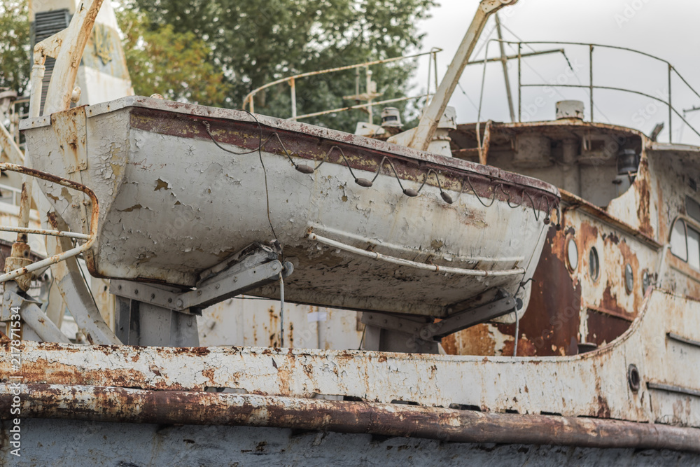 Rusty weathered old white fishing boat in the harbor on the Dnieper River, Ukraine Rusty weathered old white fishing boat in the harbor on the Dnieper River, Ukraine