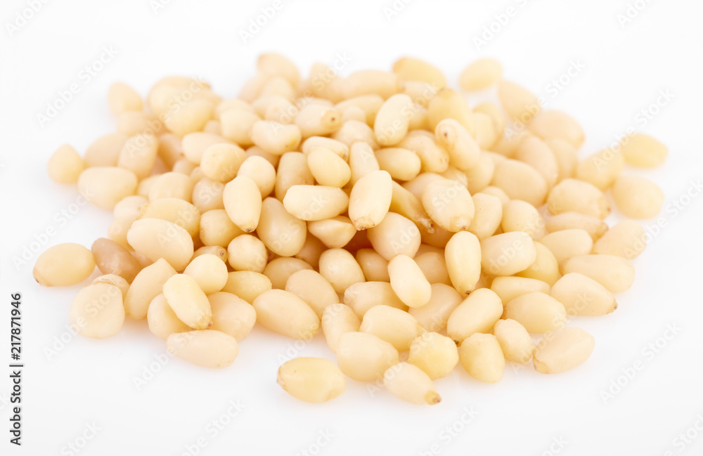 Peeled pine nuts on a white background. Healthy food. Nuts. Peeled pine nuts on a white background. Healthy food. Nuts.
