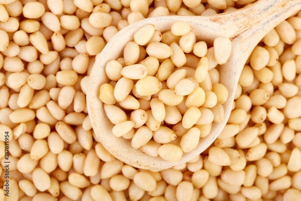 Peeled pine nuts on a white background. Healthy food. Nuts. Peeled pine nuts on a white background. Healthy food. Nuts.