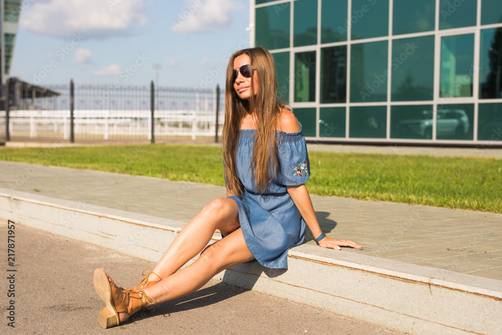 Fototapeta premium Girl sitting on street in summer day