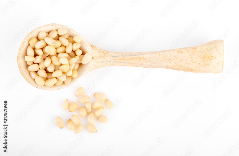 Peeled pine nuts on a white background. Healthy food. Nuts. Peeled pine nuts on a white background. Healthy food. Nuts.