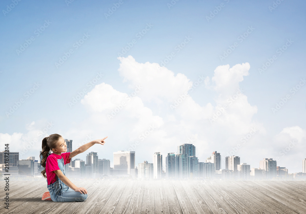 Concept of careless happy childhood with girl dreaming about something Concept of careless happy childhood with girl dreaming about something