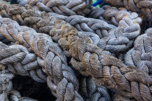 Old braided rope on the wooden deck of a sea boat