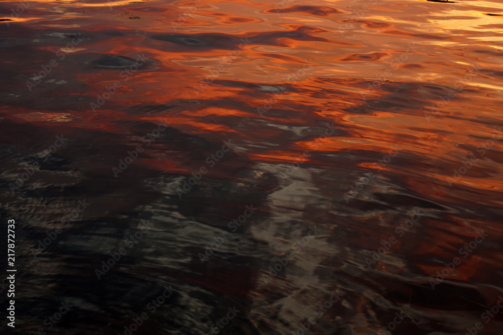 Orange sun set reflecting in the sea with fishers plunk Orange sun set reflecting in the sea with fishers plunk