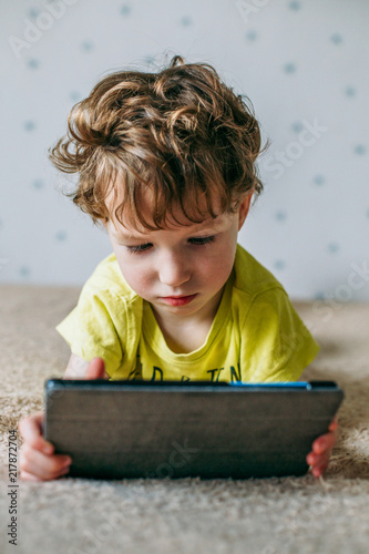 Toddler boy staring at tablet. Education, gadget, dependency, technology, addiction, child eyesight, raising children concept
