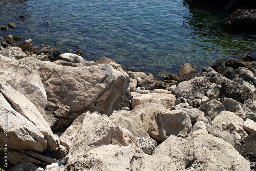 Rocky bay with giant boulders and a clear blue water Rocky bay with giant boulders and a clear blue water