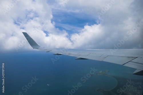 Wing of airplane in the air with cloud