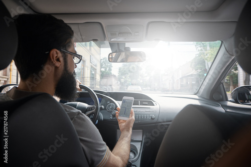 Man using mobile phone while driving. © arthurhidden