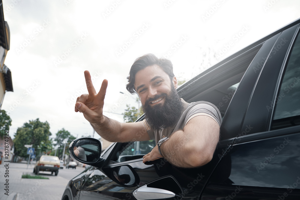 Close up side portrait of happy man driving car