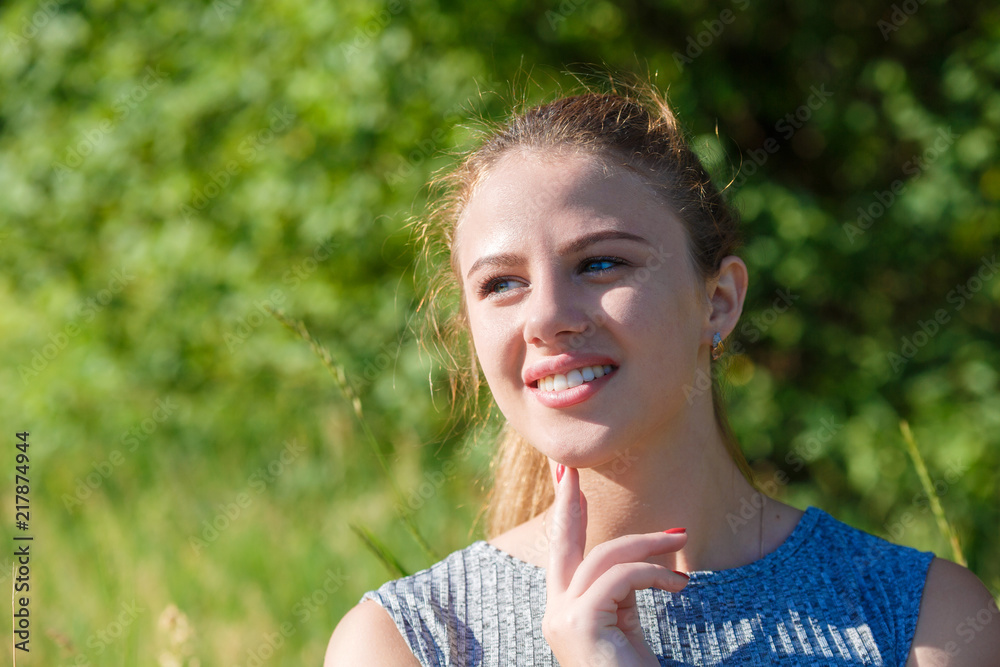 smiling girl on the background of green nature. smiling girl on the background of green nature.