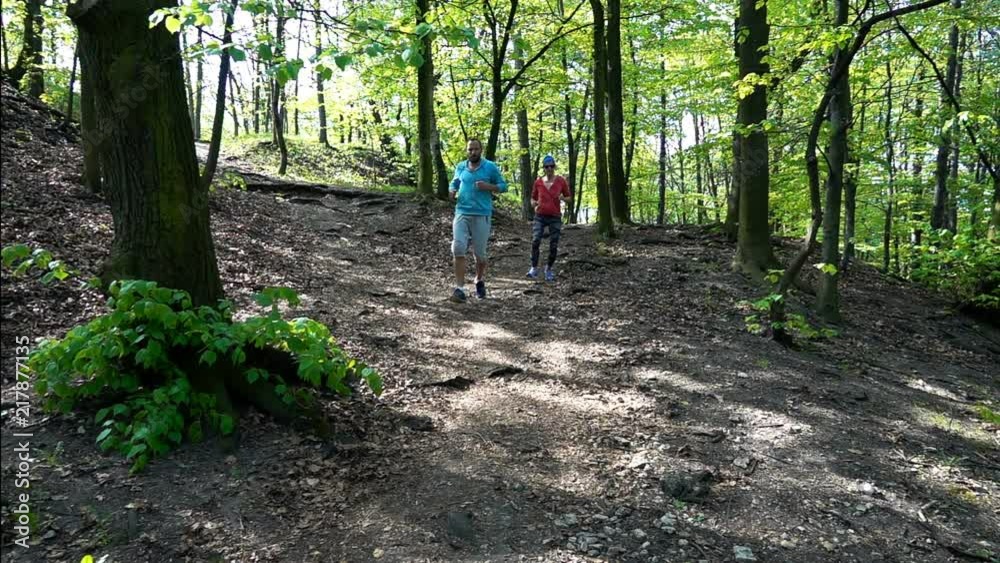 Active couple jogging in the park, forest, super slow motion
Active couple jogging in the park, forest, super slow motion