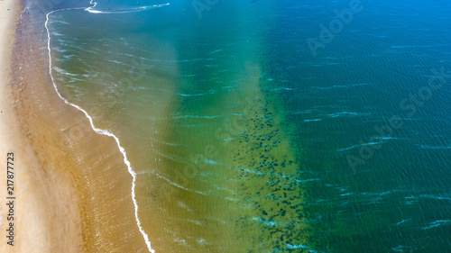 Beach and ocean waves from above taken by a drone in Zeeland in the Netherlands