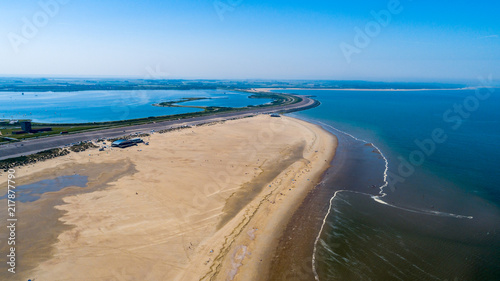 Beach and ocean waves from above taken by a drone in Zeeland in the Netherlands